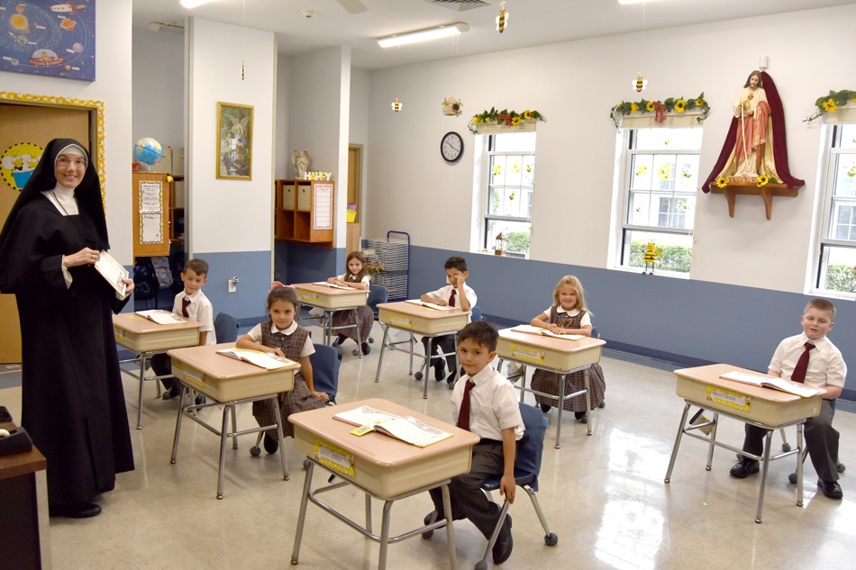 A Sister teaching young students in their classroom