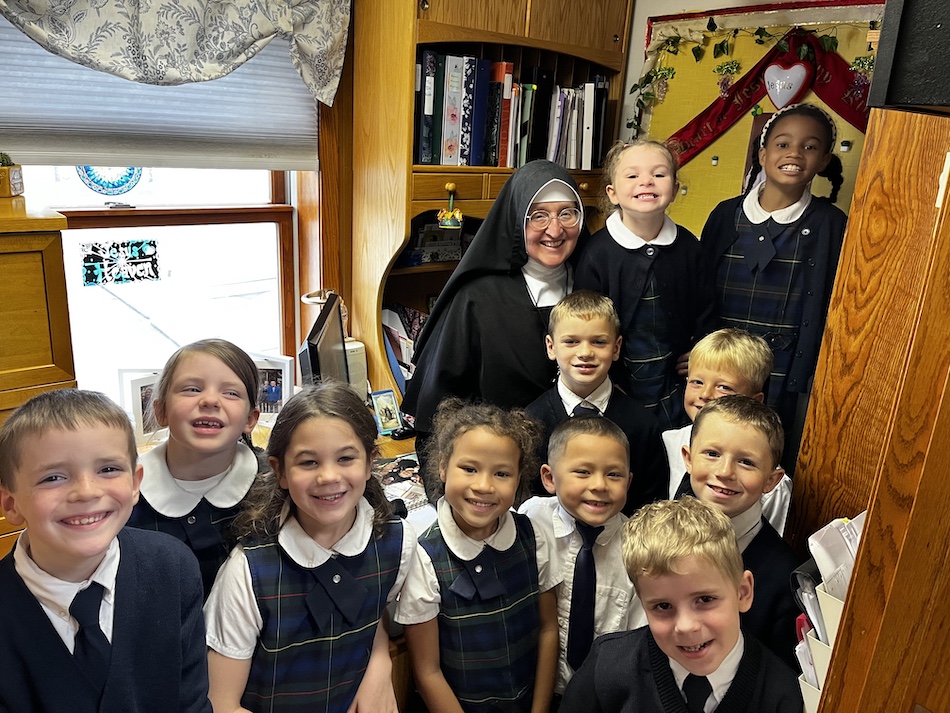 A Sister visiting with schoolchildren in her office