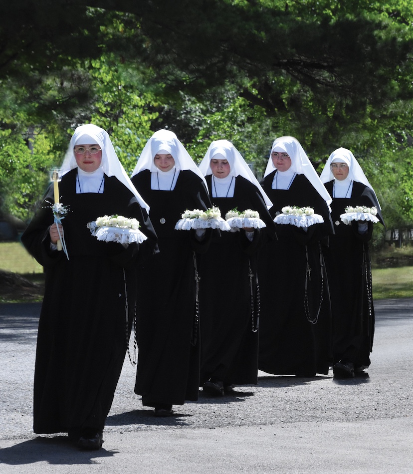 Novices in procession carrying flowers