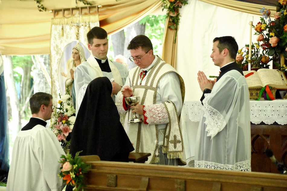 A Sister receiving Holy Communion at July 2nd Ceremonies
