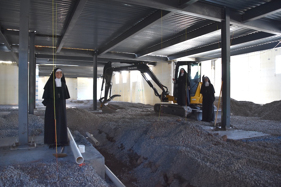 Sisters visiting the building site among the steel framing